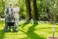 Senior man with volunteer in the garden of professional care home Royalty Free Stock Photo