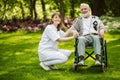Man with helpful volunteer in the garden of professional care home Royalty Free Stock Photo