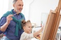 Senior man and his grandchild drawing an image Royalty Free Stock Photo