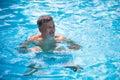 Senior man in his home swimming pool Royalty Free Stock Photo