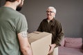 Senior Man And His Son Carrying Boxes Royalty Free Stock Photo