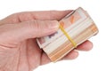Senior man hold in hand cash of three thousand euros in fifty euro bills  are twisted into a roll isolated macro Royalty Free Stock Photo
