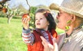 Senior man holding adorable little girl picking