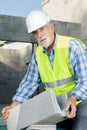senior man holding bloc cement outdoors