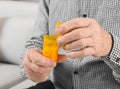 Senior man holding bottle of pills indoors, Royalty Free Stock Photo