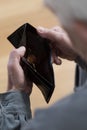 Senior man holding empty wallet Royalty Free Stock Photo