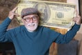 Senior man holding gigantic 100 dollars bill Royalty Free Stock Photo