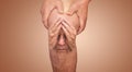 Senior man holding the knee with pain. Collage. Concept of abstract pain and despair. Royalty Free Stock Photo