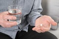 Senior man holding pill and glass of water Royalty Free Stock Photo