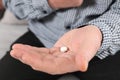 Senior man holding pill in hand Royalty Free Stock Photo