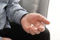 Senior man holding pill in hand Royalty Free Stock Photo