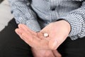 Senior man holding pill in hand Royalty Free Stock Photo