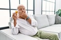 Senior man holding pills shocked covering mouth with hands for mistake Royalty Free Stock Photo