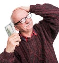 Senior man holding a stack of money. Portrait of an excited old businessman