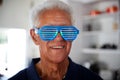 Senior Man At Home Wearing Novelty Party Glasses Royalty Free Stock Photo