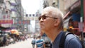 Senior man with hong kong urban architecture scene Royalty Free Stock Photo