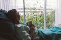Senior Man On A Hospital Bed Alone In A Room Looking Through The Hospital Window. Elderly Patient.