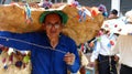 Senior man in huge hat as mythical character of Taita Carnival