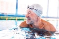 Senior man in an indoor swimming pool. Royalty Free Stock Photo