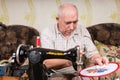 Senior Man Inspecting Needle Point Stitches Royalty Free Stock Photo