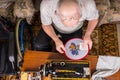 Senior Man Inspecting Needlepoint Work Royalty Free Stock Photo