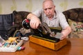 Senior Man Inspecting Vintage Sewing Machine Royalty Free Stock Photo
