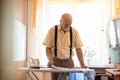 Senior man ironing his clothes Royalty Free Stock Photo