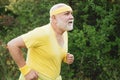 Senior man jogging in park. Like sports. Funny sporty old sportsman finished his work out. Old sport man running outside