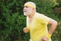 Senior man jogging in park. Like sports. Funny sporty old sportsman finished his work out. Old sport man running outside