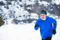 Senior man jogging in winter nature. Copy space. Royalty Free Stock Photo