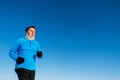 Senior man jogging in winter nature. Copy space. Royalty Free Stock Photo