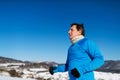 Senior man jogging in winter nature. Copy space. Royalty Free Stock Photo