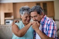 Senior man kissing his partner hand in living room Royalty Free Stock Photo