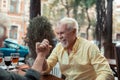 Senior man laughing while winning at arm-wrestling