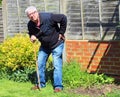 Senior man leaning on waking stick or cane.