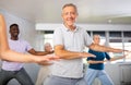 Senior man learning to dance krump with group of older people Royalty Free Stock Photo