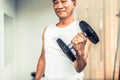 Senior man lifting dumbbell in fitness gym. Royalty Free Stock Photo