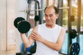 Senior man lifting dumbbell in fitness gym. Royalty Free Stock Photo