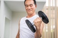 Senior man lifting dumbbell in fitness gym. Royalty Free Stock Photo