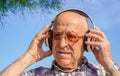 Senior man listen to music with earphones. wellness in elderly. Mental health