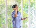 A senior man listening to music via headphones with wireless tablet computer in hand with happiness manner. Idea for a lifestyle Royalty Free Stock Photo