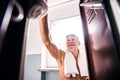 Senior man by the lockers in an indoor swimming pool. Royalty Free Stock Photo