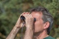 Senior man looking through binoculars Royalty Free Stock Photo