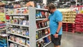 A senior man looking at a book display in a retail store to buy and read