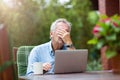 Senior man looking stressed while working on laptop Royalty Free Stock Photo