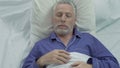 Senior man loudly snoring and puffing in bed, sleeping problems at old age