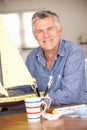 Senior man making a model ship Royalty Free Stock Photo