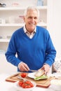 Senior Man Making Sandwich In Kitchen Royalty Free Stock Photo