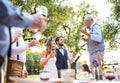 A senior man making speech at wedding reception outside in the background. Royalty Free Stock Photo