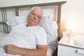 Senior man male bed home tired sick ill alone retired unhappy sad sleeping